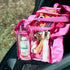 Pink Campaq clear toiletry storage bag packed with toiletries in a car boot — Adventure Awaits