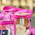 Close up of pink Campaq clear toiletry storage bag with branded zips and towel inside — Adventure Awaits