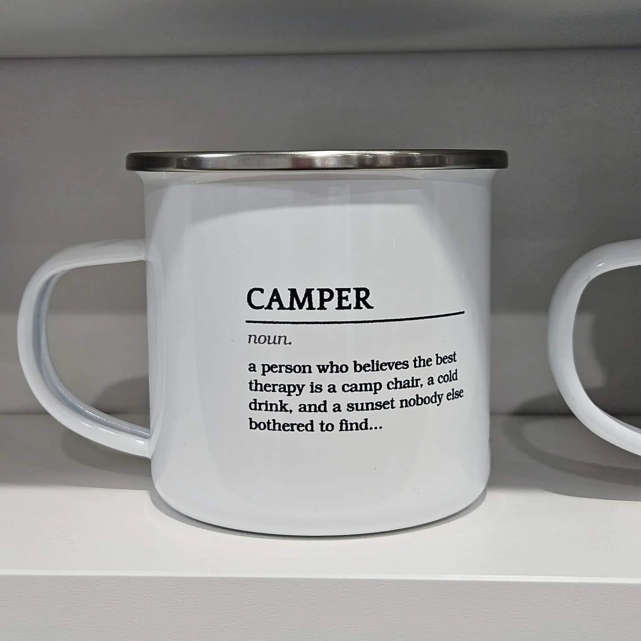 "Camper" definition enamel mug on display shelf — funny camping gift for caravanners and outdoor lovers — Adventure Awaits