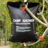 Black inflatable camp shower with text and connectors hanging outdoors.