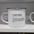 White mug with 'CAMP MUM' definition text on a shelf