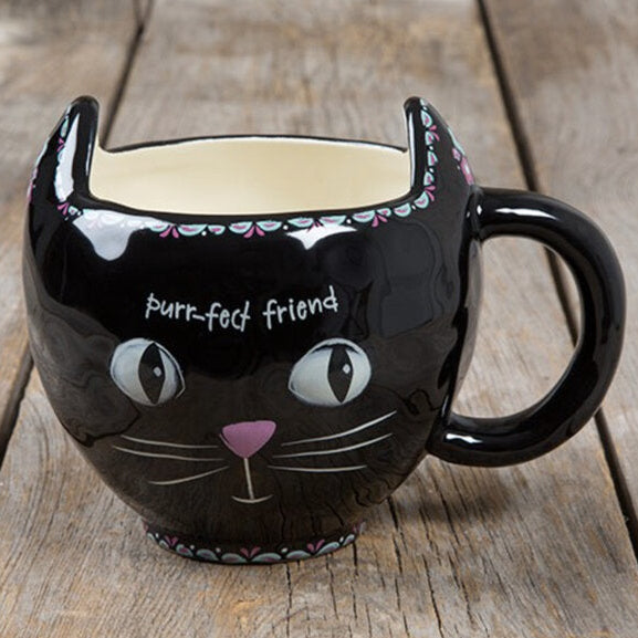 Black cat-shaped mug with 'purr-fect friend' text on a wooden surface