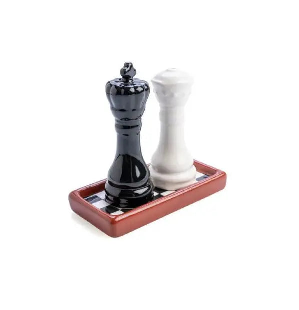 Chess salt and pepper shakers standing on checkerboard tray — Adventure Awaits