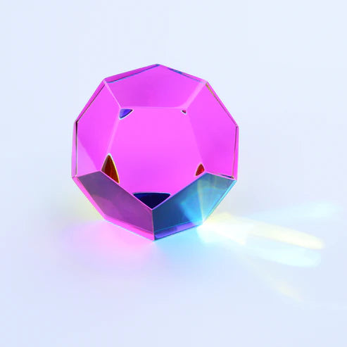 CMY Cubes Mundus pink dodecahedron casting soft rainbow light on a pale background — Adventure Awaits