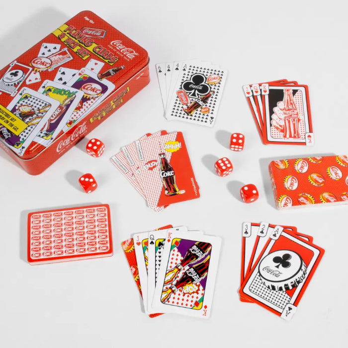 Coca-Cola playing cards and dice set laid out with red collectible tin — Adventure Awaits