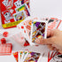 Hand holding Coca-Cola playing cards with dice and collectible tin — Adventure Awaits