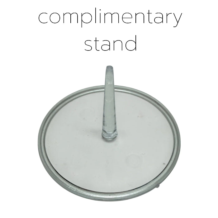 Clear glass cake stand with a handle on a white background, labeled 'complimentary stand'.