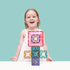smiling child with colourful Connetix magnetic tile structure, creative construction toy for imaginative play and learning at home or travel Adventure Awaits