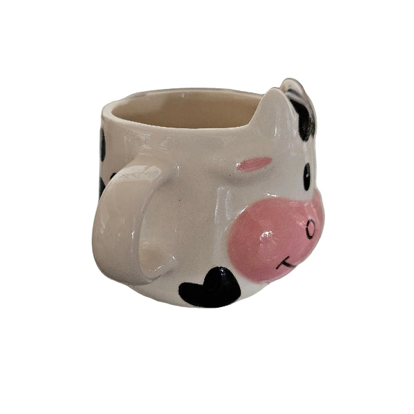 cow-shaped mug with a pink nose on a blurred background