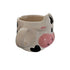 cow-shaped mug with a pink nose on a blurred background
