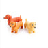 Three sausage dog figurines in orange and yellow colours for playful kids fun — Adventure Awaits