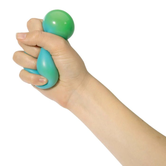 Hand squeezing blue and green Crush It! super sensory ball for tactile play — Adventure Awaits