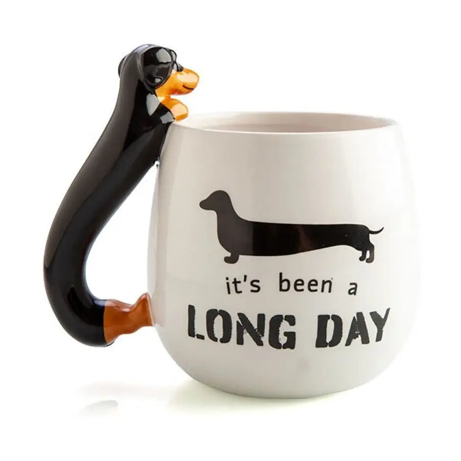 White mug with black dachshund handle and long day slogan — Adventure Awaits