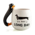 White mug with black dachshund handle and long day slogan — Adventure Awaits