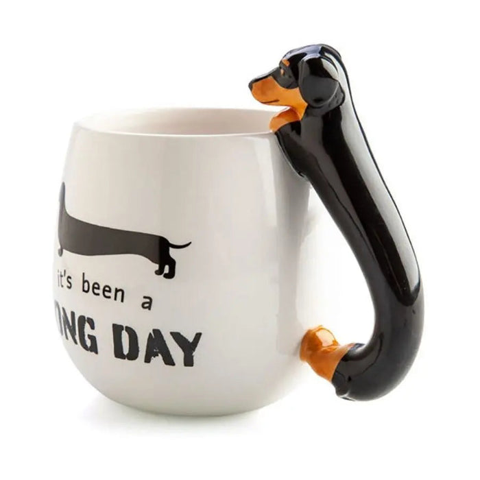 White mug with black 3D dachshund handle and long day slogan — Adventure Awaits