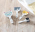 Cat ceramic measuring spoons on wooden bench with tea towel — Adventure Awaits
