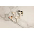Ceramic cow, pig, sheep and rooster measuring spoons arranged on a marble bench — Adventure Awaits