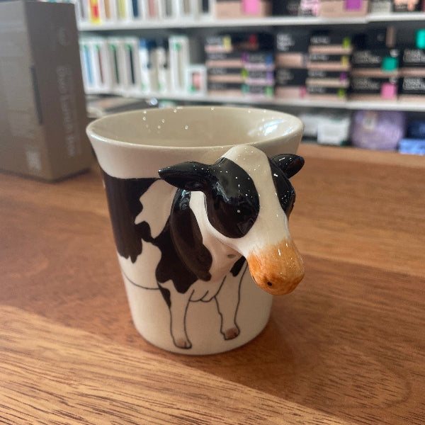 Ceramic mug with a cow head handle