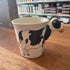 Ceramic mug with a cow head handle