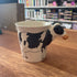Ceramic mug with a cow head handle