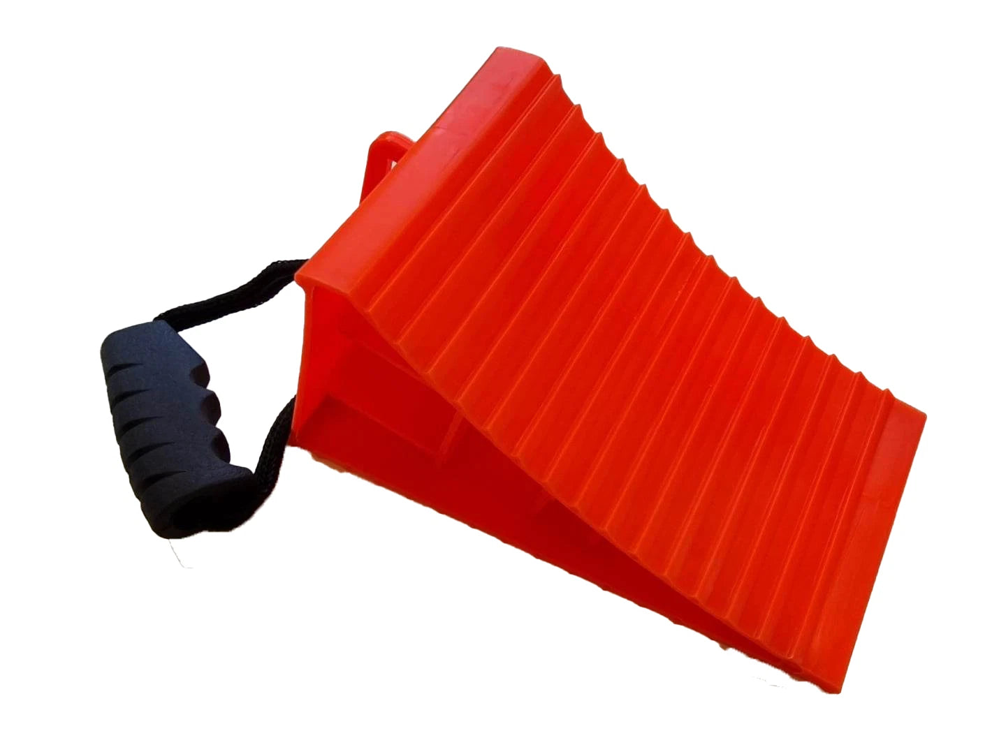 Red wheel chock with ribbed grip surface and black pull handle on white background — Adventure Awaits