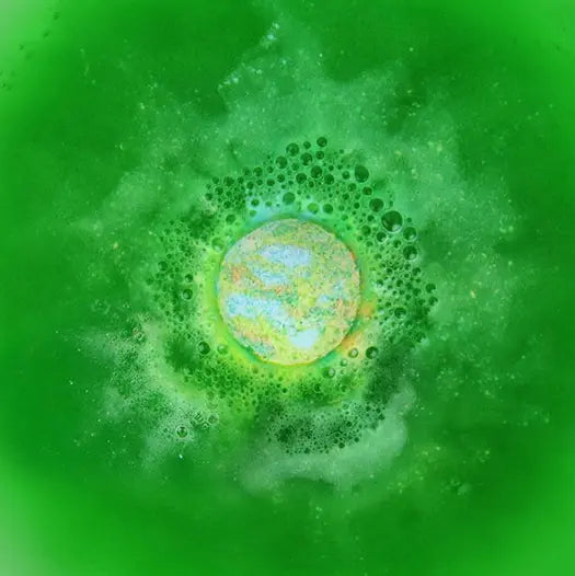 Dino Poop bath bomb fizzing in bright green bath water — Adventure Awaits