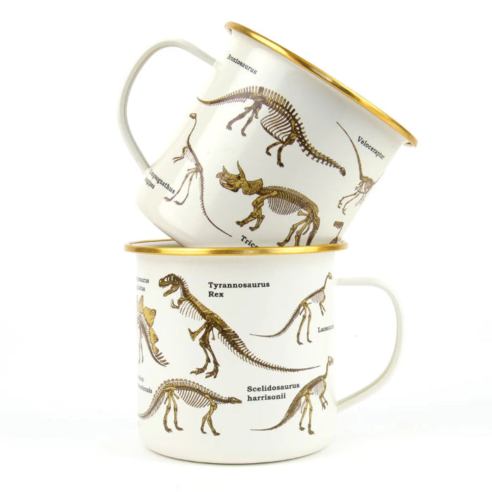 Two cream enamel dinosaur mugs stacked with gold rims and skeleton illustrations Adventure Awaits