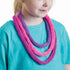 child wearing handmade knitted cord necklace in pink and purple from French knitting kit, creative kids craft result Adventure Awaits