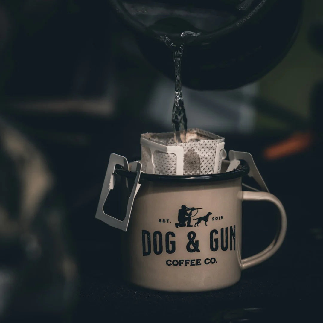 Hot water poured over Dog & Gun drip bag coffee in enamel camp mug — Adventure Awaits