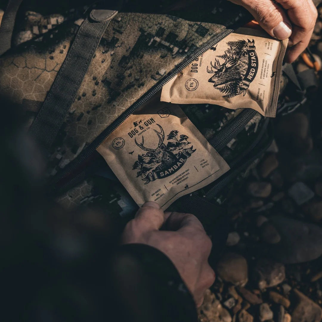 Dog & Gun Red Stag and Sambar coffee sachets packed in outdoor adventure bag — Adventure Awaits