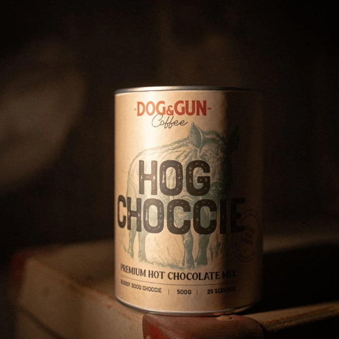 Dog & Gun Hog Choccie premium hot chocolate tin in moody rustic setting — Adventure Awaits