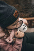 Child sipping Dog & Gun hot chocolate from enamel camp mug outdoors — Adventure Awaits