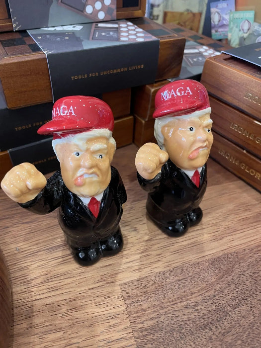 Presidential caricature salt and pepper shakers with red MAGA caps on wooden shop shelf — Adventure Awaits