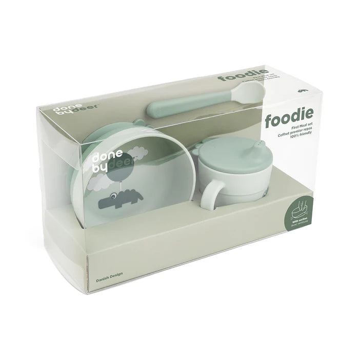 Done by Deer Foodie baby meal set in green tones with bowl, spoon and cup in retail packaging, practical feeding essential for home or travel Adventure Awaits