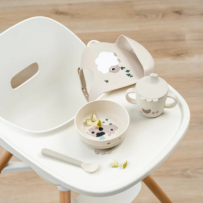Baby feeding set with suction bowl, spoon, handled cup and bib on high chair, designed for easy mess free mealtimes at home or travel Adventure Awaits
