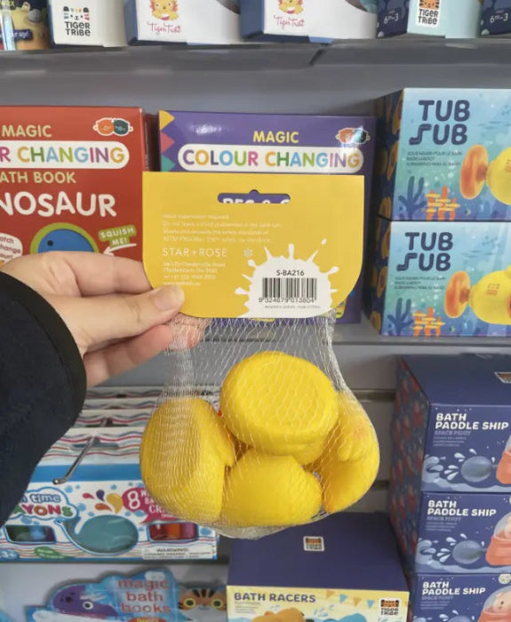 Hand holding Star + Rose Duck Ducky Duckiest yellow bath squirters in a mesh bag — Adventure Awaits