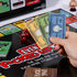 Board game with cards and dice on a table, featuring explicit language.