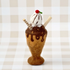 Felted ice cream cone toy on a checkered background
