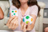 Person holding a Tri-Match challenge card and colourful Fidget About It puzzle ball — Adventure Awaits