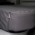 Close-up of MeanderWild caolmine grey flannelette fitted sheet corner with zipper closure on a caravan bed — Adventure Awaits
