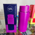 Purple reusable water bottle with packaging on a reflective surface