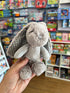 grey spotty frankie bunny in hand with store in background