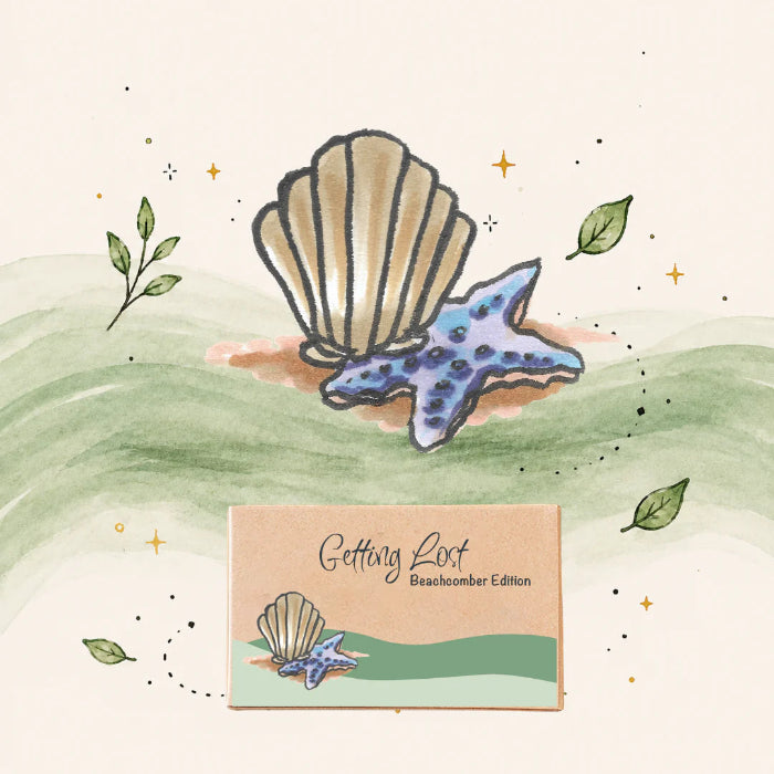 Getting Lost Beachcomber Edition card game box beneath an illustrated shell and blue starfish, Adventure Awaits
