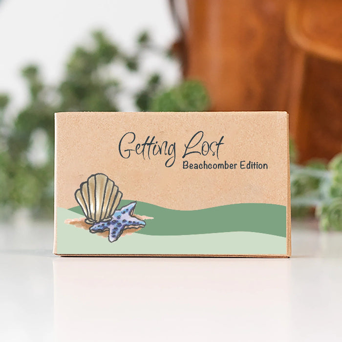 Getting Lost Beachcomber Edition card game box with illustrated shell and blue starfish, Adventure Awaits