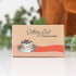 Getting Lost Christmas Edition travel card game box with illustrated strawberry pancakes, Adventure Awaits