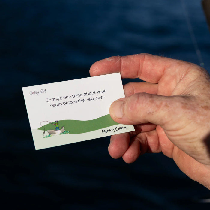 Hand holds a Getting Lost Fishing Edition card prompting a setup change before the next cast, Adventure Awaits