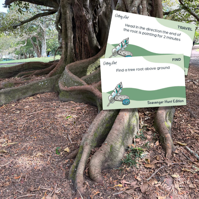 Scavenger Hunt Edition cards on giant tree roots for outdoor travel play — Adventure Awaits