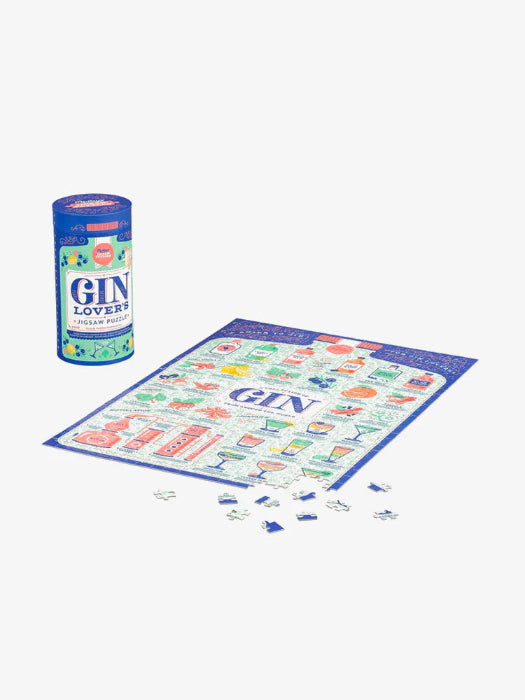 Gin Lover’s 500-piece jigsaw puzzle beside blue gift tube and loose pieces — Adventure Awaits