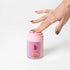 Hand pressing the pump on pink GGO Juicee 100 ml water-based lubricant, Adventure Awaits