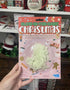 Hand holding Glow-in-the-Dark Christmas wall decorations pack with 14 festive shapes — Adventure Awaits